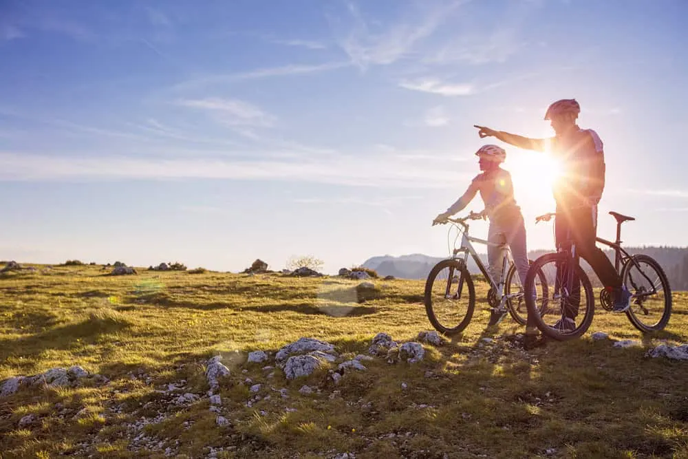 Biker couple enjoying outdoor activities aiding addiction recovery and reducing substance abuse chances