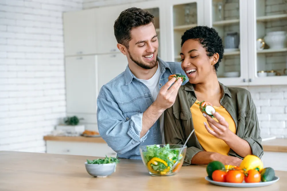 young-couple-eating-healthy-food-in-kitchen-healthy-fats-early-recovery-addiction-treatment-plan-long-term-physical-health-prevent-health-issues-from-nutritional-deficiencies
