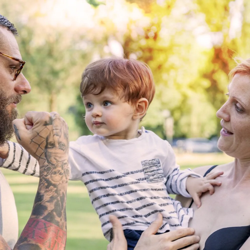 Parents spending time outdoors with their young child