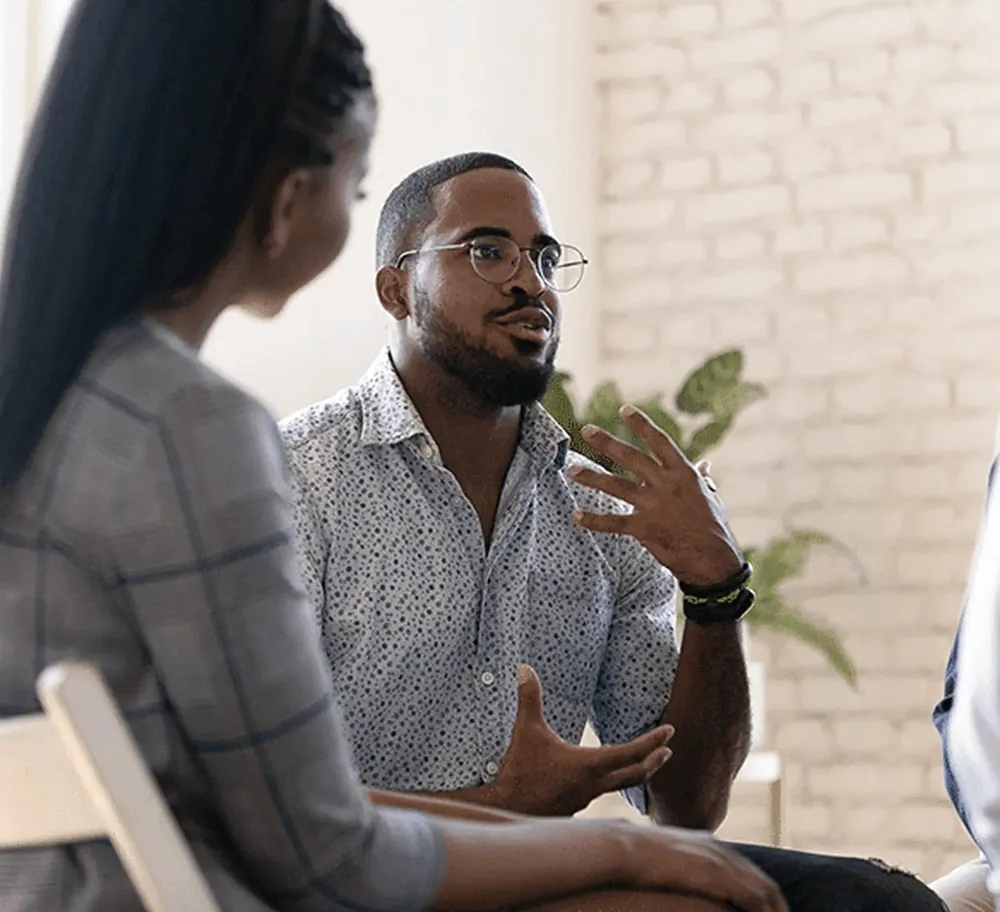Man talking with a peer in a support group