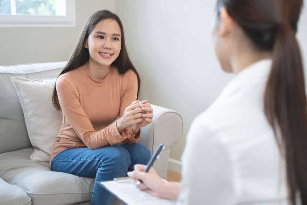 Young woman in a therapy session exploring holistic treatment options for substance abuse and rehabilitation