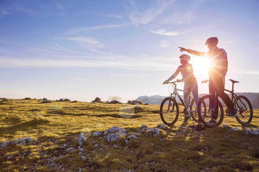 Biker couple enjoying outdoor activities aiding addiction recovery and reducing substance abuse chances