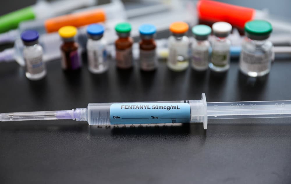 Synthetic opioids substance abuse and drug potency issues represented by fentanyl syringes anesthetics and muscle relaxers highlighting the opioid epidemic and narcotic misuse crisis