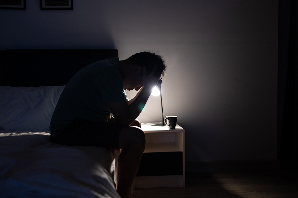 depressed-unemployed-man-sitting-in-dark-bedroom-illegal-drugs-substance-use-disorder-prescription-drugs-psychological-distress-young-adults