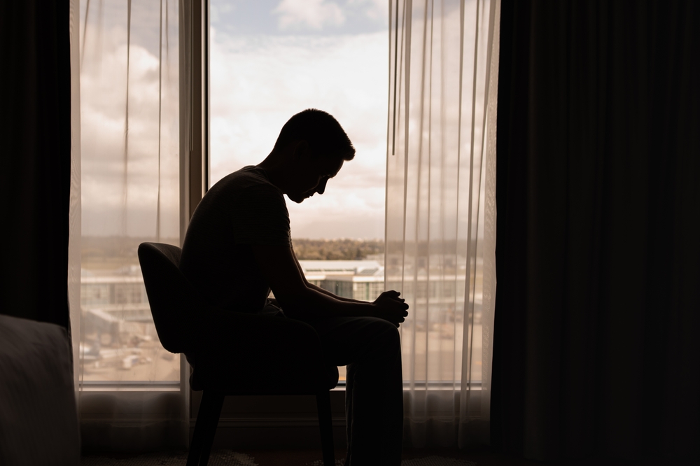 loneliness-man-sitting-in-a-window-alone-drug-or-alcohol-addiction-sober-friends-long-term-sobriety-risk-of-relapsing-normal-part-of-recovery