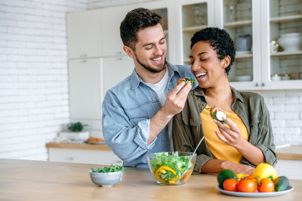 young-couple-eating-healthy-food-in-kitchen-healthy-fats-early-recovery-addiction-treatment-plan-long-term-physical-health-prevent-health-issues-from-nutritional-deficiencies